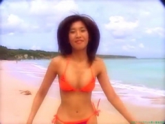 Chisato Morishita frolicking on the beach in an orange bikini002