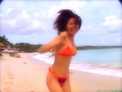 Chisato Morishita frolicking on the beach in an orange bikini007