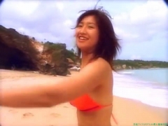 Chisato Morishita frolicking on the beach in an orange bikini009