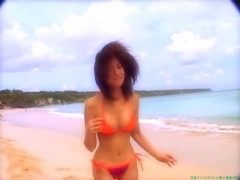 Chisato Morishita frolicking on the beach in an orange bikini015
