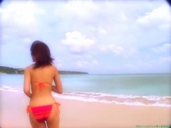 Chisato Morishita frolicking on the beach in an orange bikini020