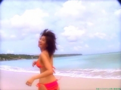 Chisato Morishita frolicking on the beach in an orange bikini021