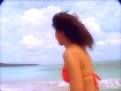 Chisato Morishita frolicking on the beach in an orange bikini023
