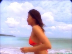 Chisato Morishita frolicking on the beach in an orange bikini024