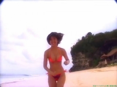 Chisato Morishita frolicking on the beach in an orange bikini031
