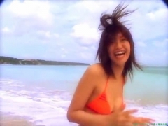 Chisato Morishita frolicking on the beach in an orange bikini039