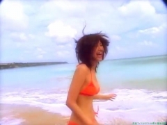 Chisato Morishita frolicking on the beach in an orange bikini040