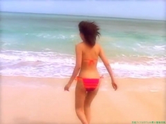 Chisato Morishita frolicking on the beach in an orange bikini051
