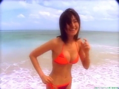 Chisato Morishita frolicking on the beach in an orange bikini057