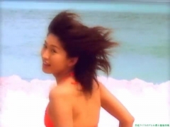 Chisato Morishita frolicking on the beach in an orange bikini062