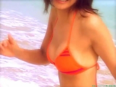 Chisato Morishita frolicking on the beach in an orange bikini066