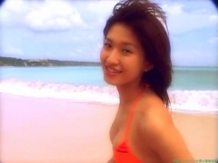 Chisato Morishita frolicking on the beach in an orange bikini071