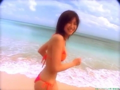 Chisato Morishita frolicking on the beach in an orange bikini089