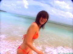 Chisato Morishita frolicking on the beach in an orange bikini090