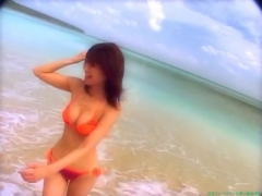Chisato Morishita frolicking on the beach in an orange bikini092