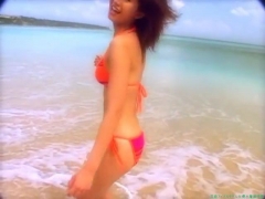 Chisato Morishita frolicking on the beach in an orange bikini093