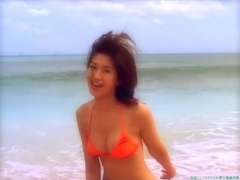 Chisato Morishita frolicking on the beach in an orange bikini095