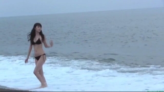 Sayumi Michishige walks along the beach in a black bikini104