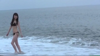 Sayumi Michishige walks along the beach in a black bikini106