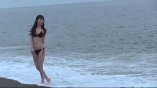 Sayumi Michishige walks along the beach in a black bikini117